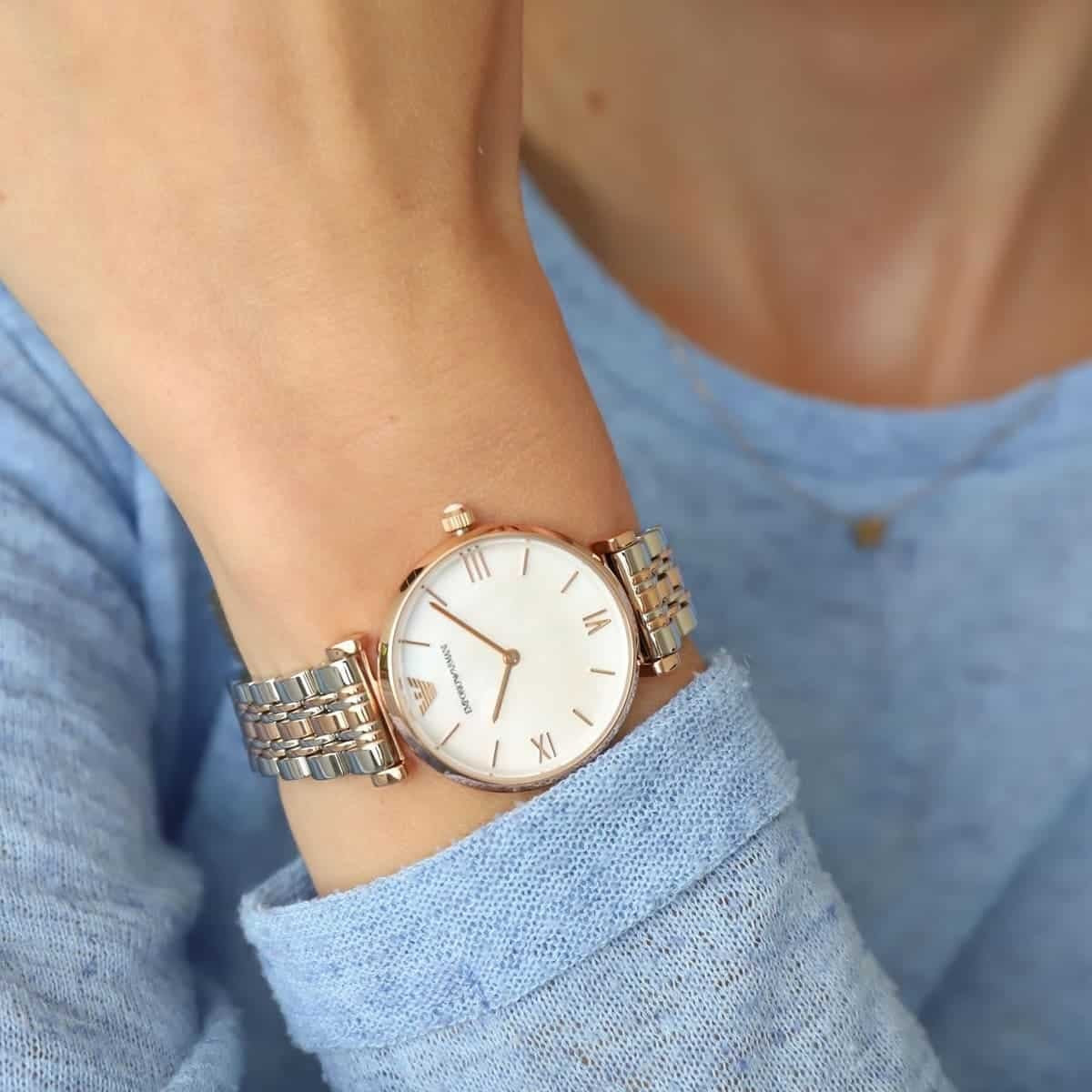 Close-up on wrist of Emporio Armani AR1683 with rose gold accents and pearl dial