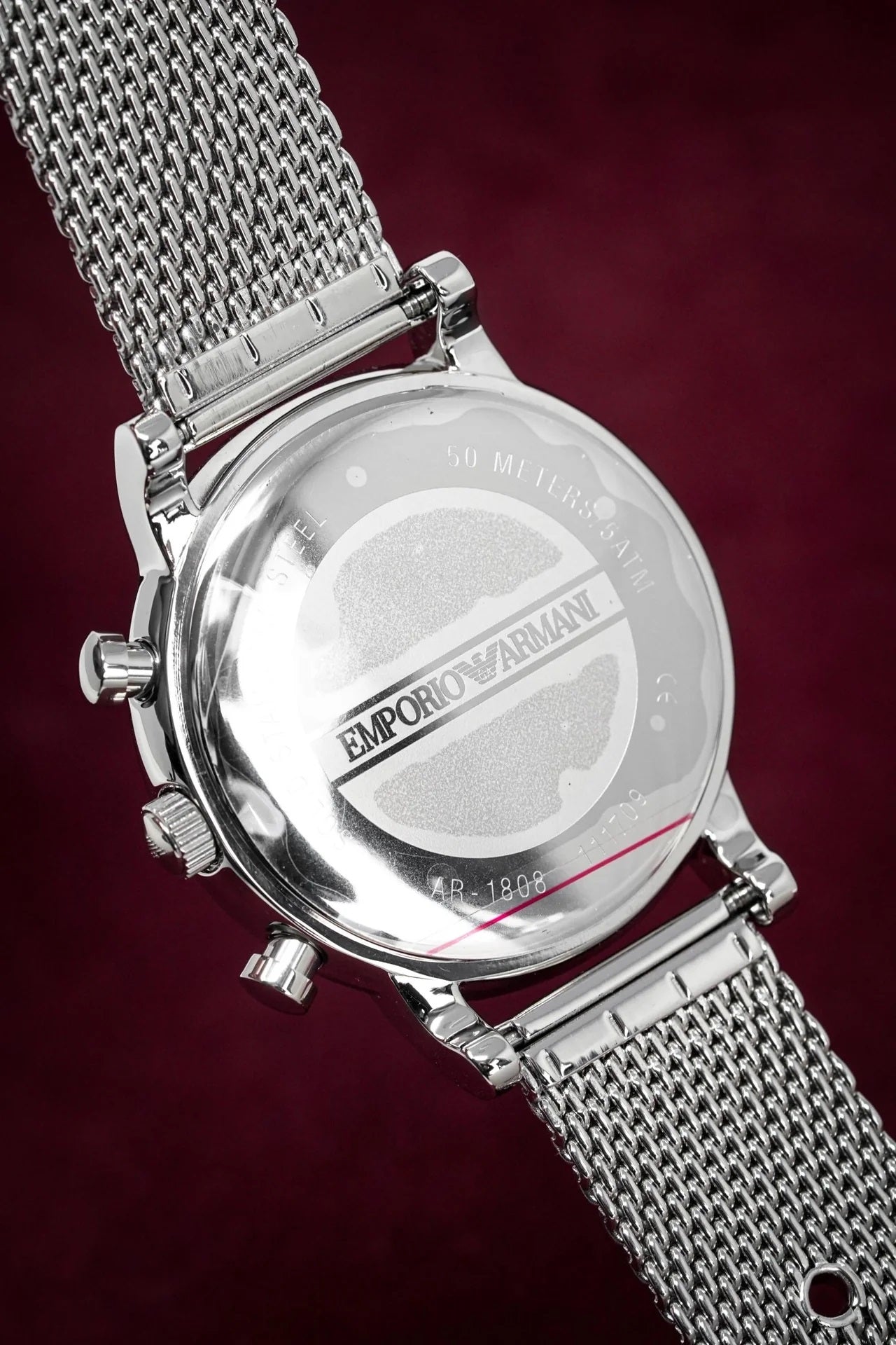 Caseback of Emporio Armani AR1808 men's watch featuring engraved stainless steel and mesh strap