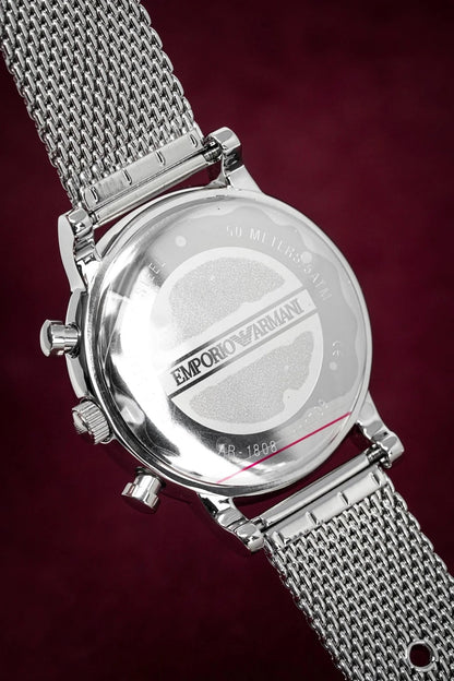 Caseback of Emporio Armani AR1808 men's watch featuring engraved stainless steel and mesh strap