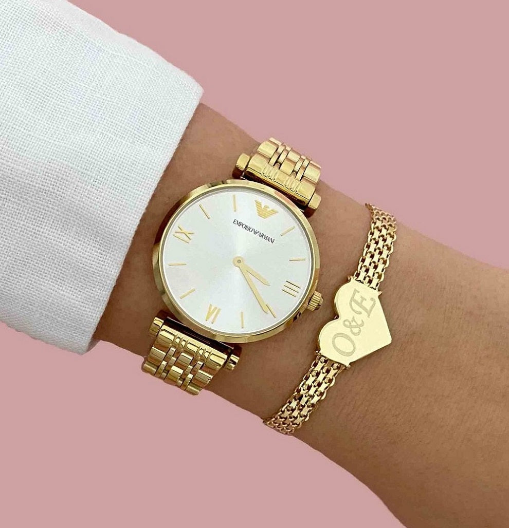 Ladies Emporio Armani AR1877 gold dress watch worn on a wrist, highlighting its slim 7mm profile and sophisticated Italian jewelry aesthetic.