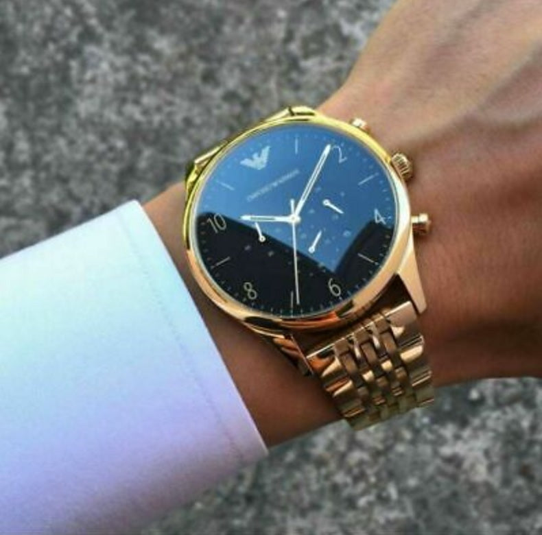 Emporio Armani AR1893 worn on wrist with gold strap and striking black dial