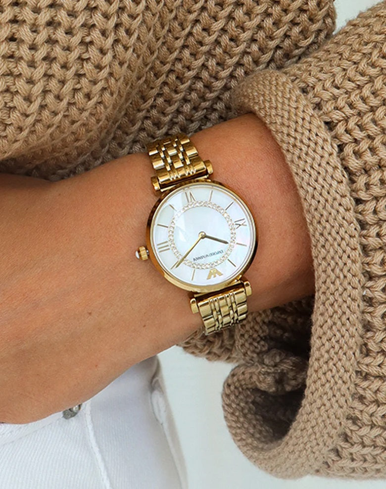 Close-up wrist shot of AR1907 Emporio Armani highlighting the delicate pearl dial and gold strap