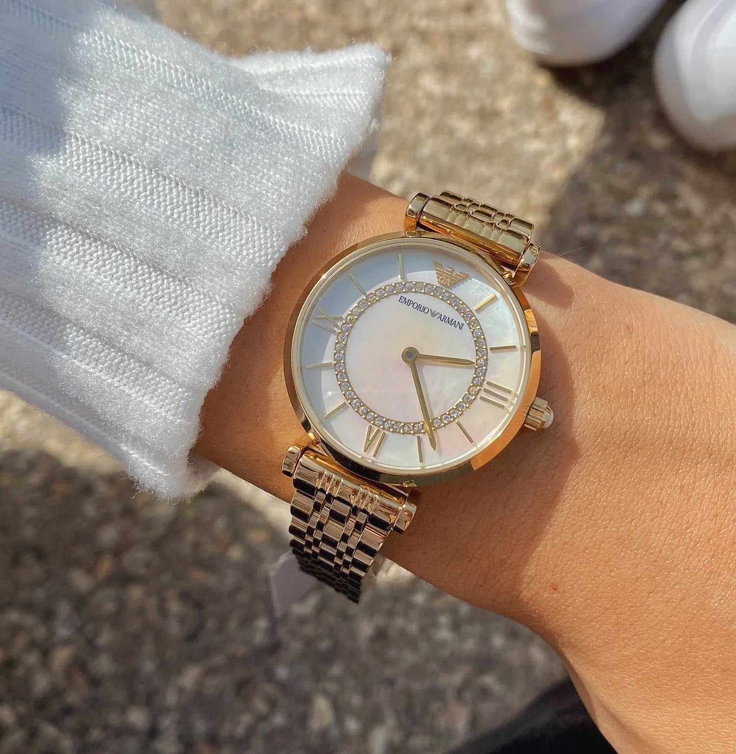 Full wrist image of Emporio Armani AR1907 with elegant gold bracelet and refined design