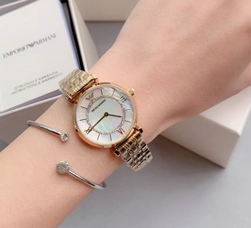 Emporio Armani AR1907 worn on wrist with gold strap and mother of pearl dial