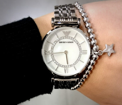 Close-up wrist shot of AR1908 Emporio Armani highlighting the lustrous pearl dial and silver strap