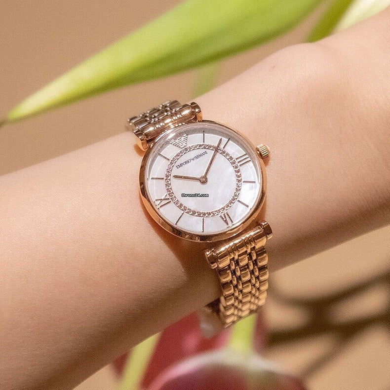 Emporio Armani AR1909 worn on wrist, featuring rose gold bracelet and pearl dial