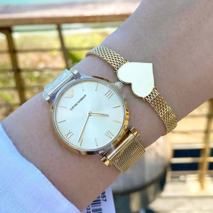 Emporio Armani AR1957 worn on wrist, featuring refined gold dial and mesh strap