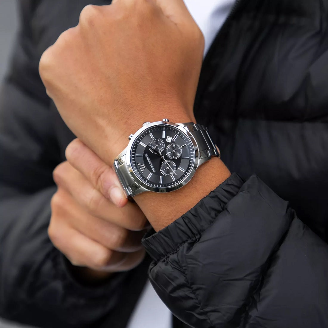 Close-up wrist shot of Emporio Armani AR2460 with black dial and silver bracelet