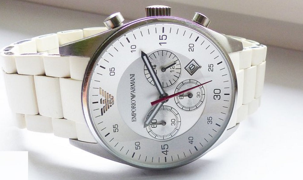 Close-up of the white dial and silver case on Emporio Armani AR5859 Sportivo men’s watch