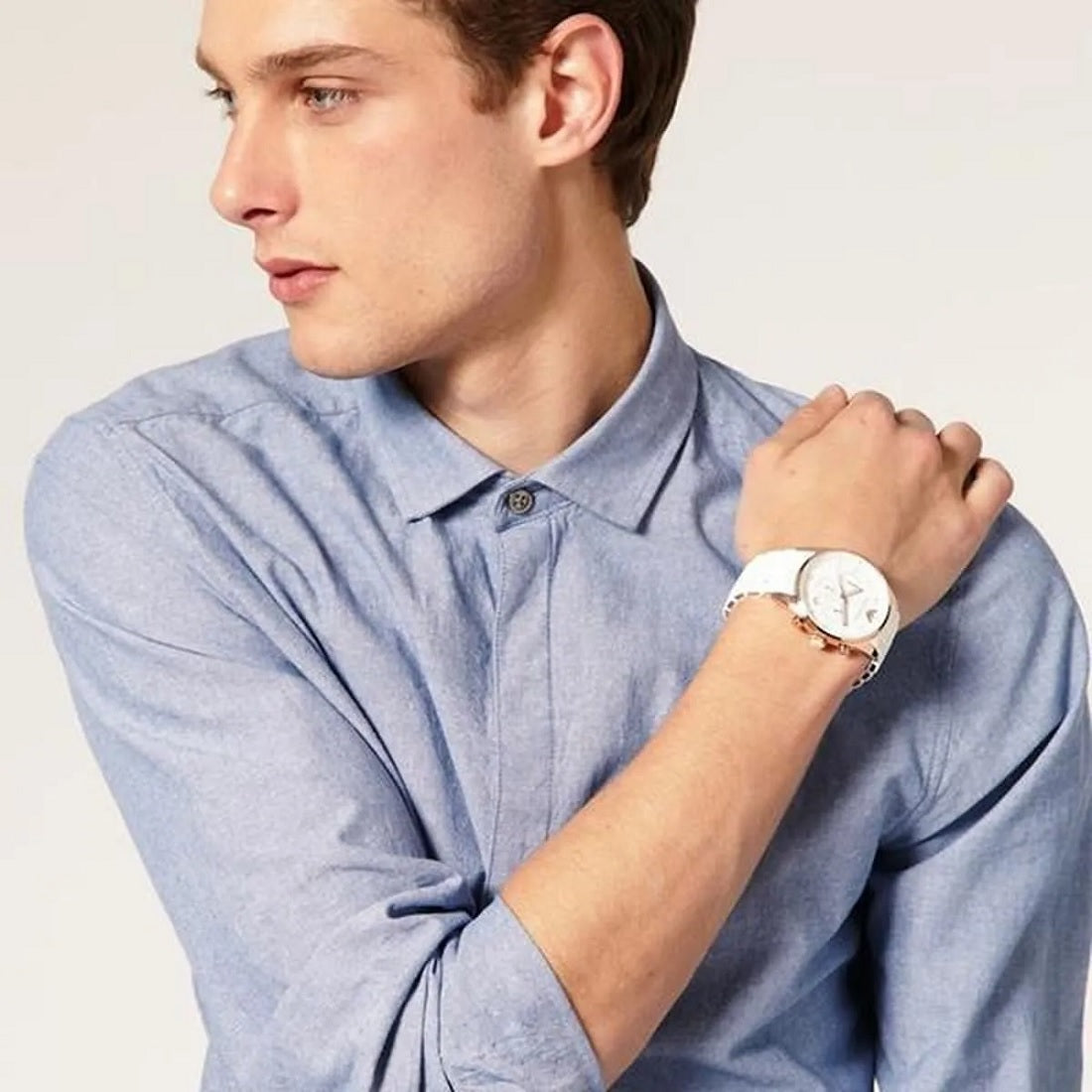 Full wrist view of Emporio Armani AR5919 Sportivo men’s watch with white silicone strap and gold case