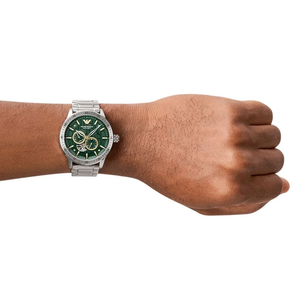 Professional lifestyle shot of the Emporio Armani AR60053 Meccanico on a wrist, showcasing the 43mm silver case and green dial contrast.