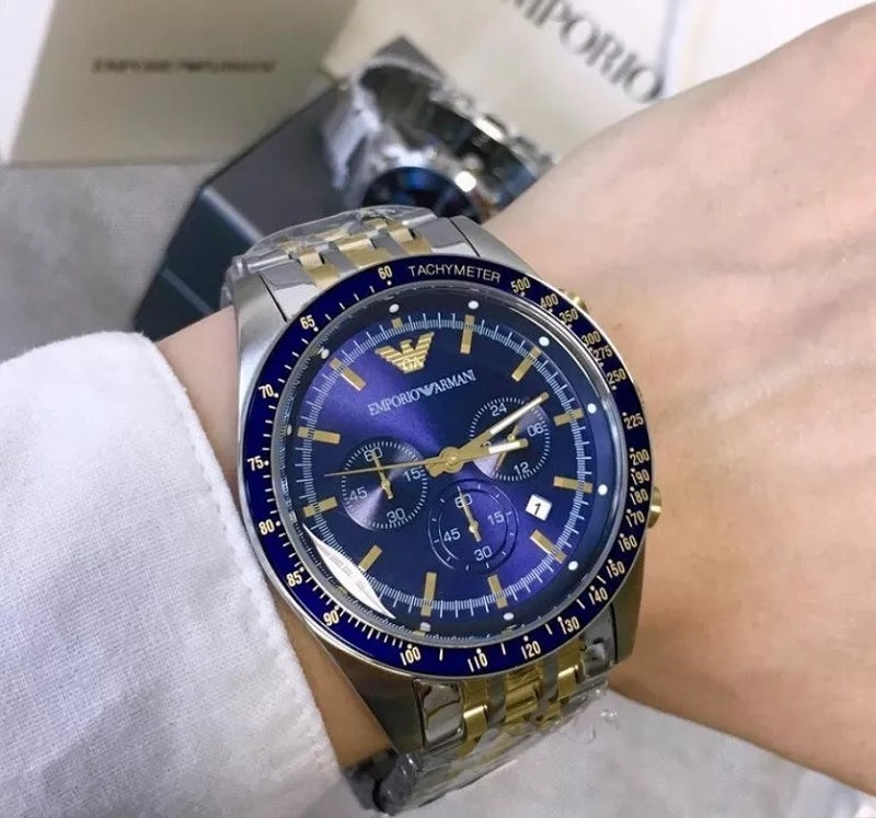 Emporio Armani AR6088 worn on wrist with navy blue dial and two-tone silver and gold-tone strap