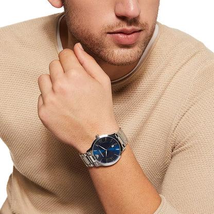 Lifestyle photography of a man wearing the Emporio Armani silver and blue watch, styled with a beige sweater to show casual wear appeal.