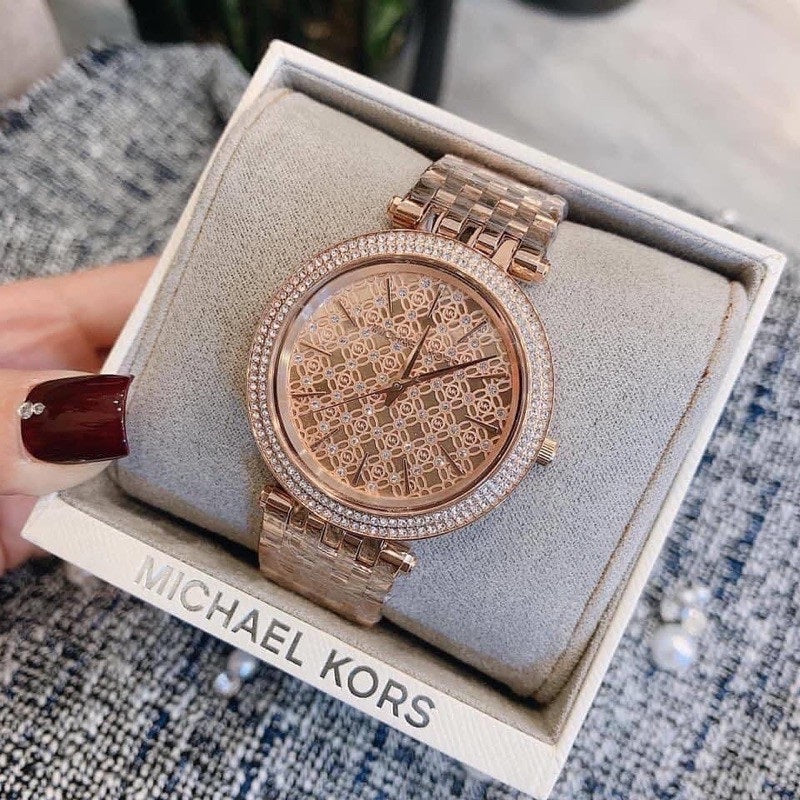Michael Kors MK3399 displayed next to original box and wrapped around branded pillow