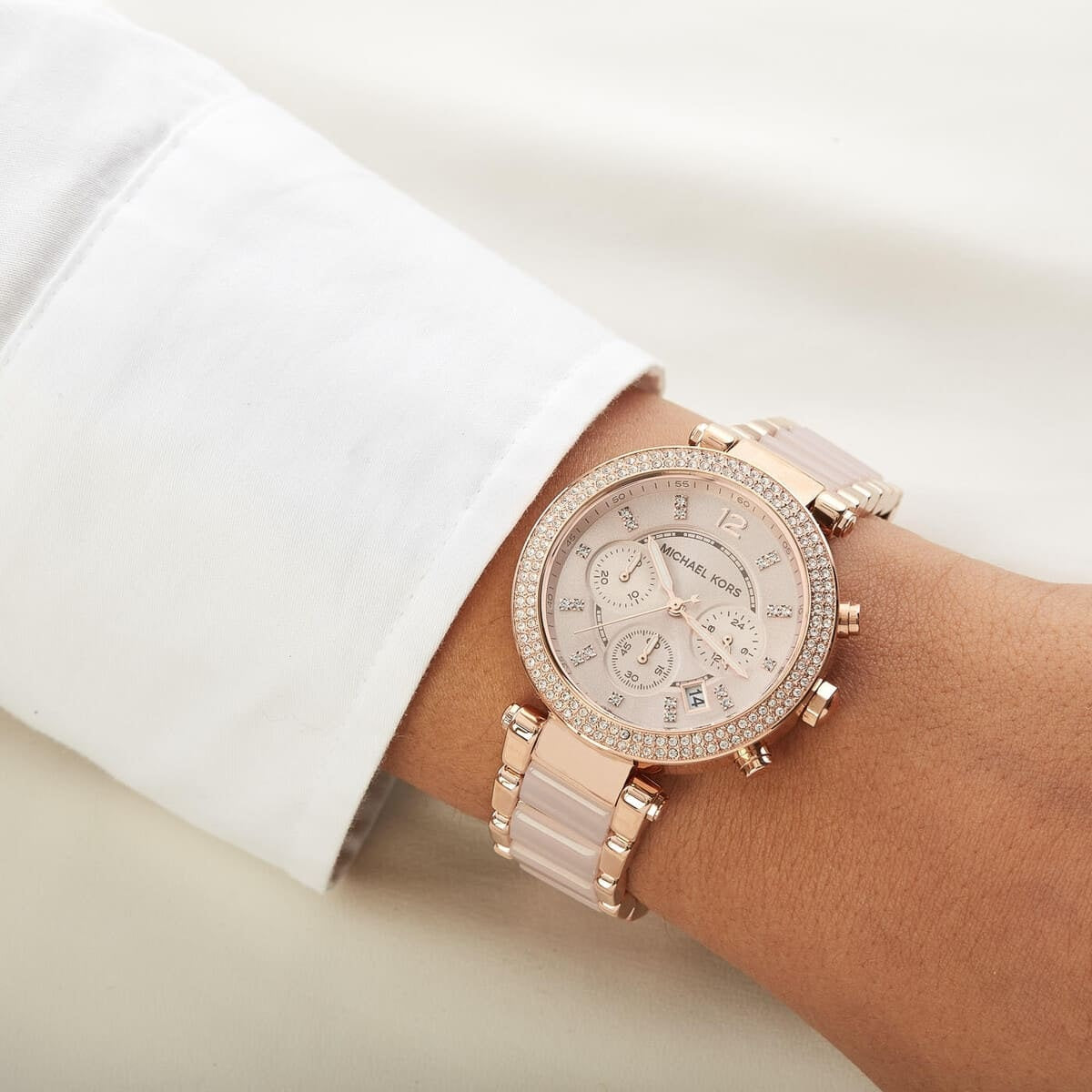 Michael Kors MK5896 women's rose gold watch worn on wrist showcasing its full design
