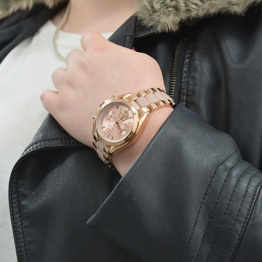 Michael Kors MK6066 women's rose gold watch with matching dial worn on wrist