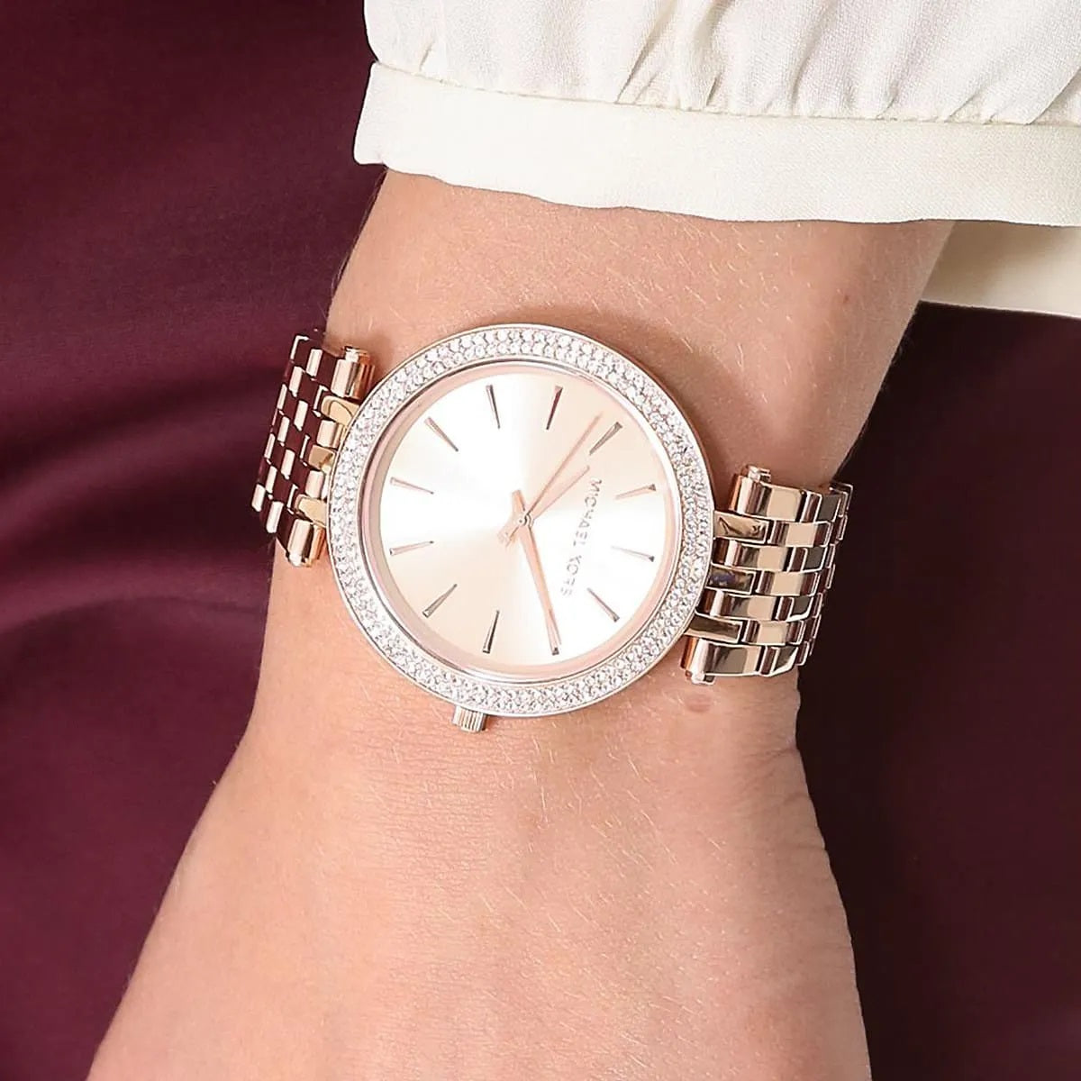 Close-up view of Michael Kors MK3192 women’s watch worn on wrist, showcasing the rose gold dial, rose gold strap, and sparkling crystals