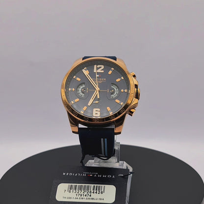 360-degree rotating view of Tommy Hilfiger 1791474 Decker men's silver watch with white dial and navy blue silicone strap.