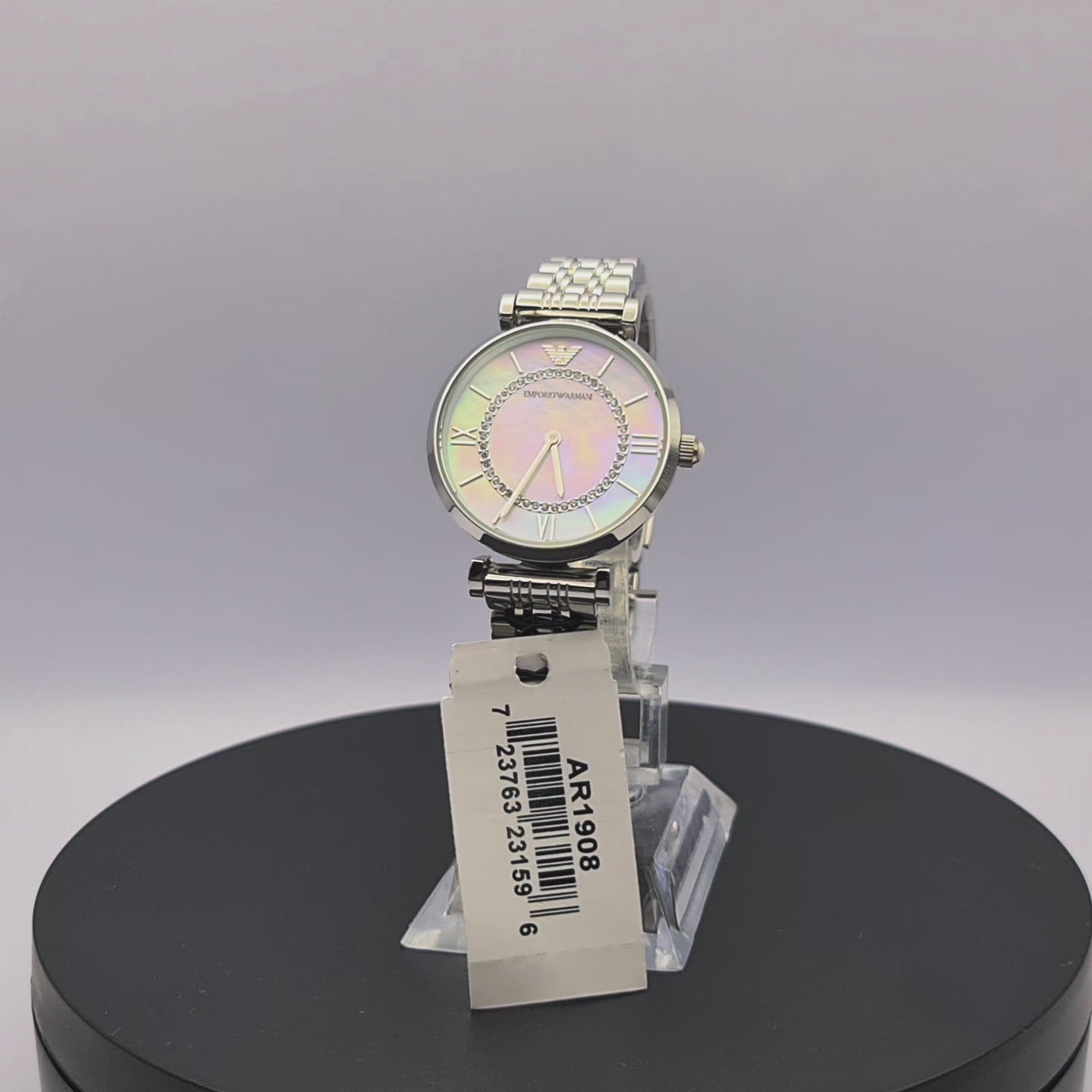 360-degree rotating view of Emporio Armani AR1908 women's silver stainless steel watch with white mother-of-pearl dial and mesh bracelet.