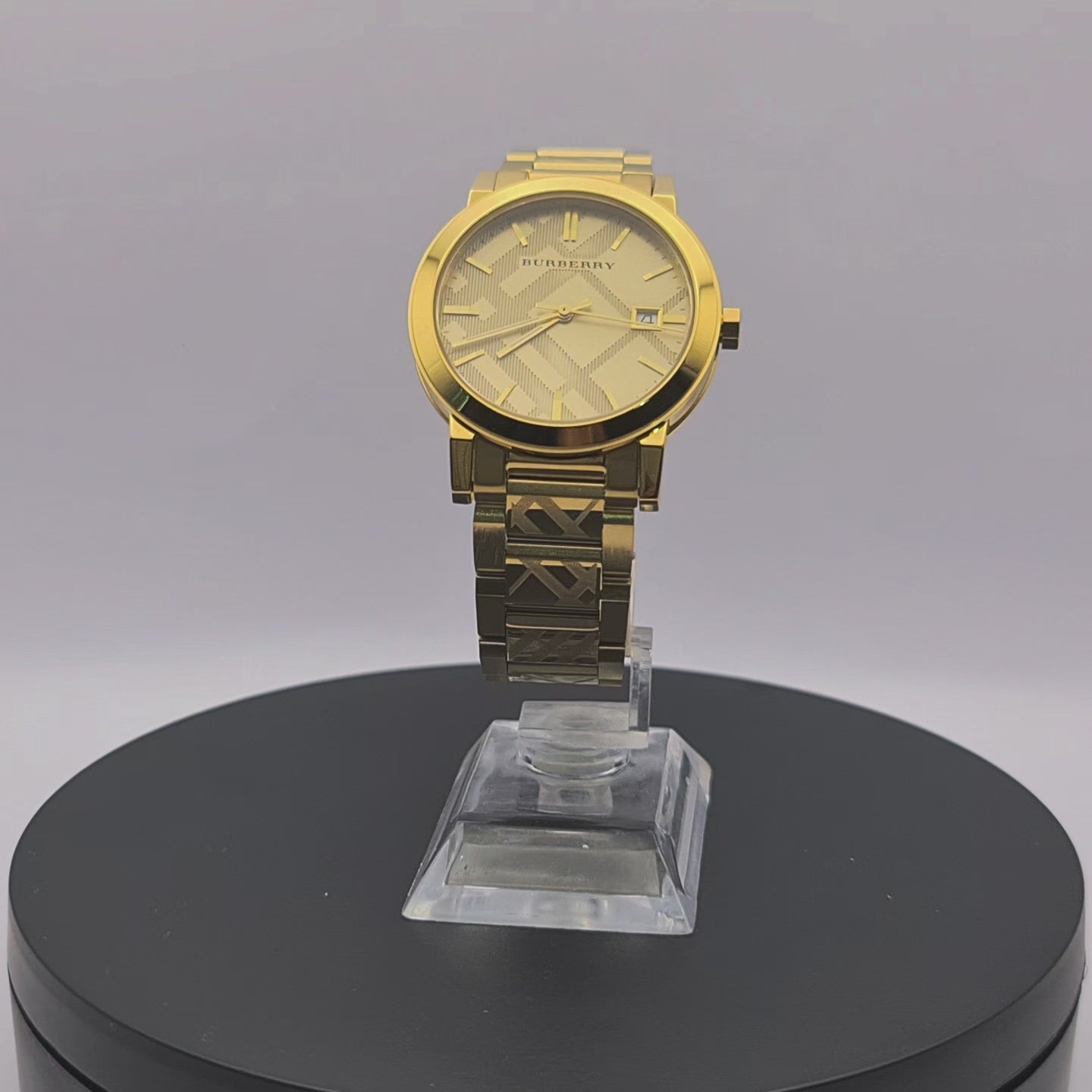 360-degree rotating view of Burberry BU9038 gold watch with engraved check pattern on dial and bracelet.