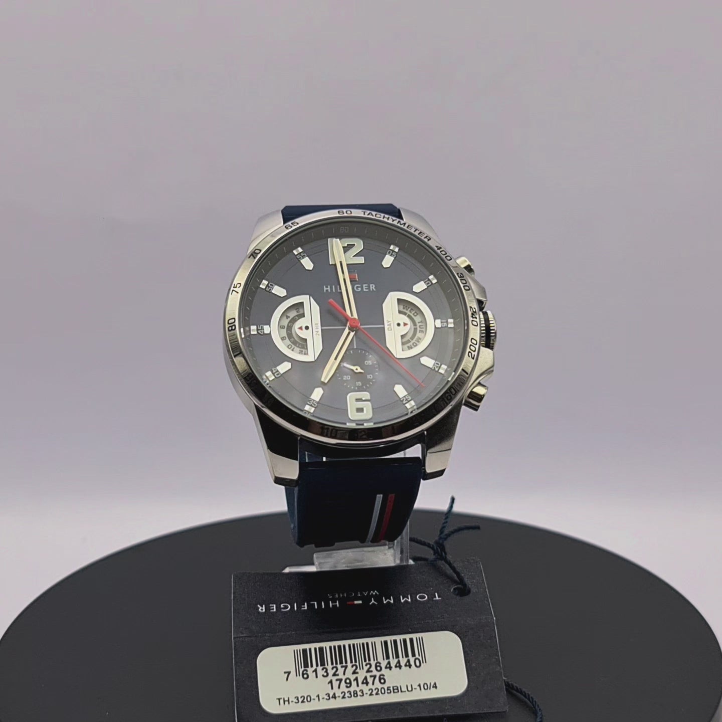 360-degree rotating view of Tommy Hilfiger 1791476 Decker men's watch with silver case and navy blue silicone strap.