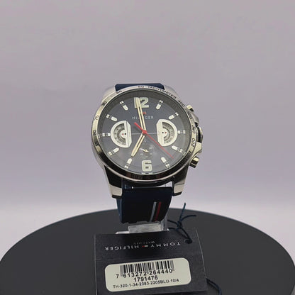 360-degree rotating view of Tommy Hilfiger 1791476 Decker men's watch with silver case and navy blue silicone strap.