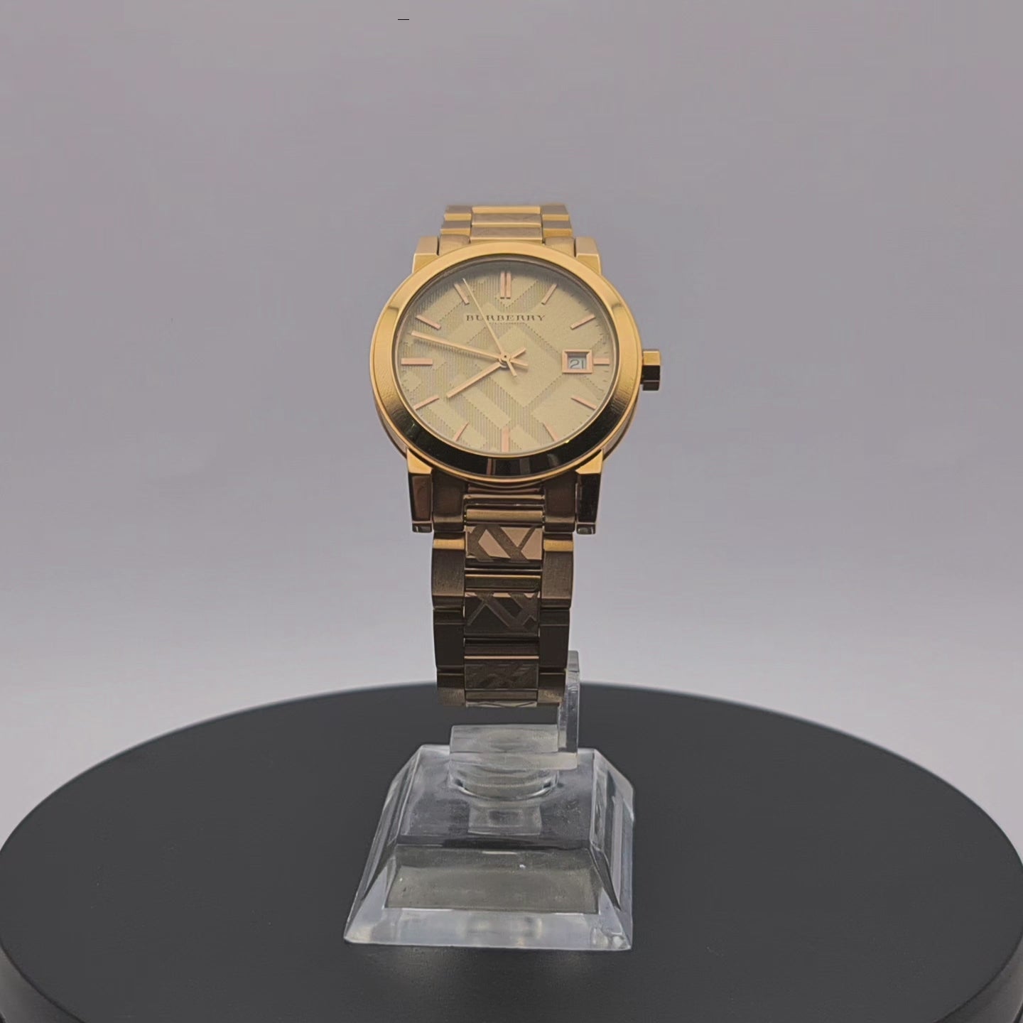 360-degree rotating view of Burberry BU9146 women's rose gold watch with engraved check bracelet.