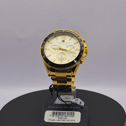 360-degree rotating view of Tommy Hilfiger 1791121 Luke men's gold-tone stainless steel watch with silver dial and blue tachymeter bezel.
