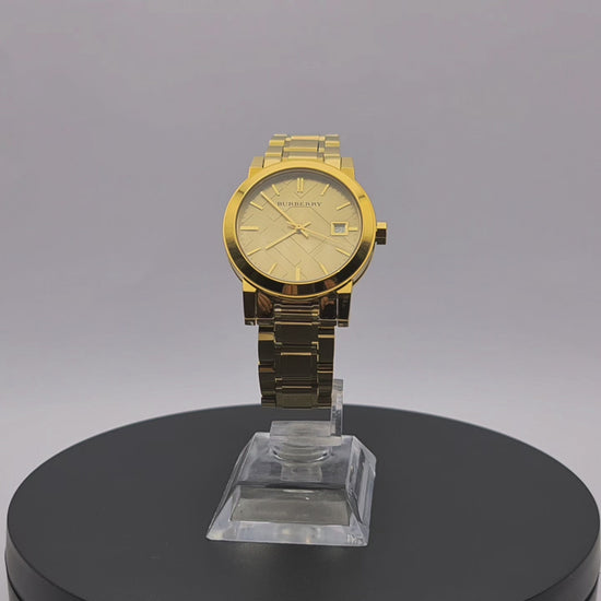 360-degree rotating view of Burberry BU9134 women's gold-tone watch with champagne check stamped dial.
