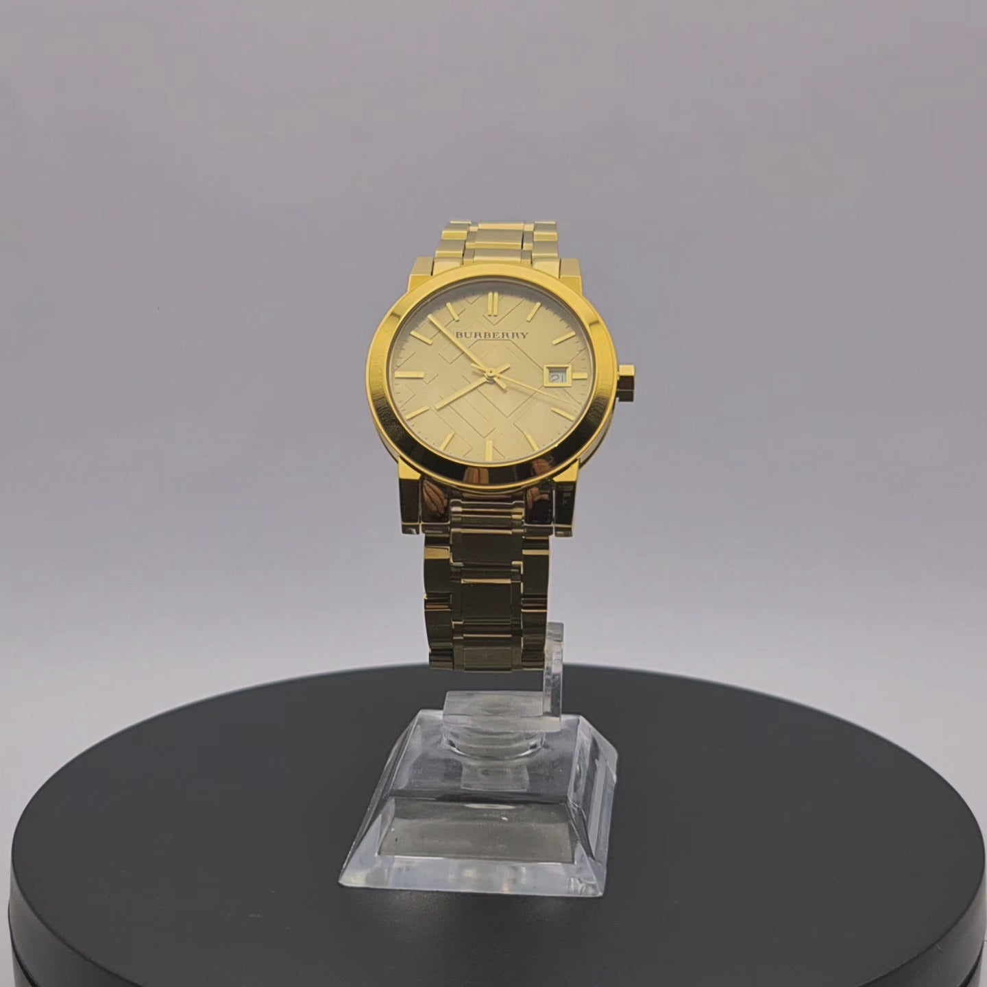 360-degree rotating view of Burberry BU9134 women's gold-tone watch with champagne check stamped dial.