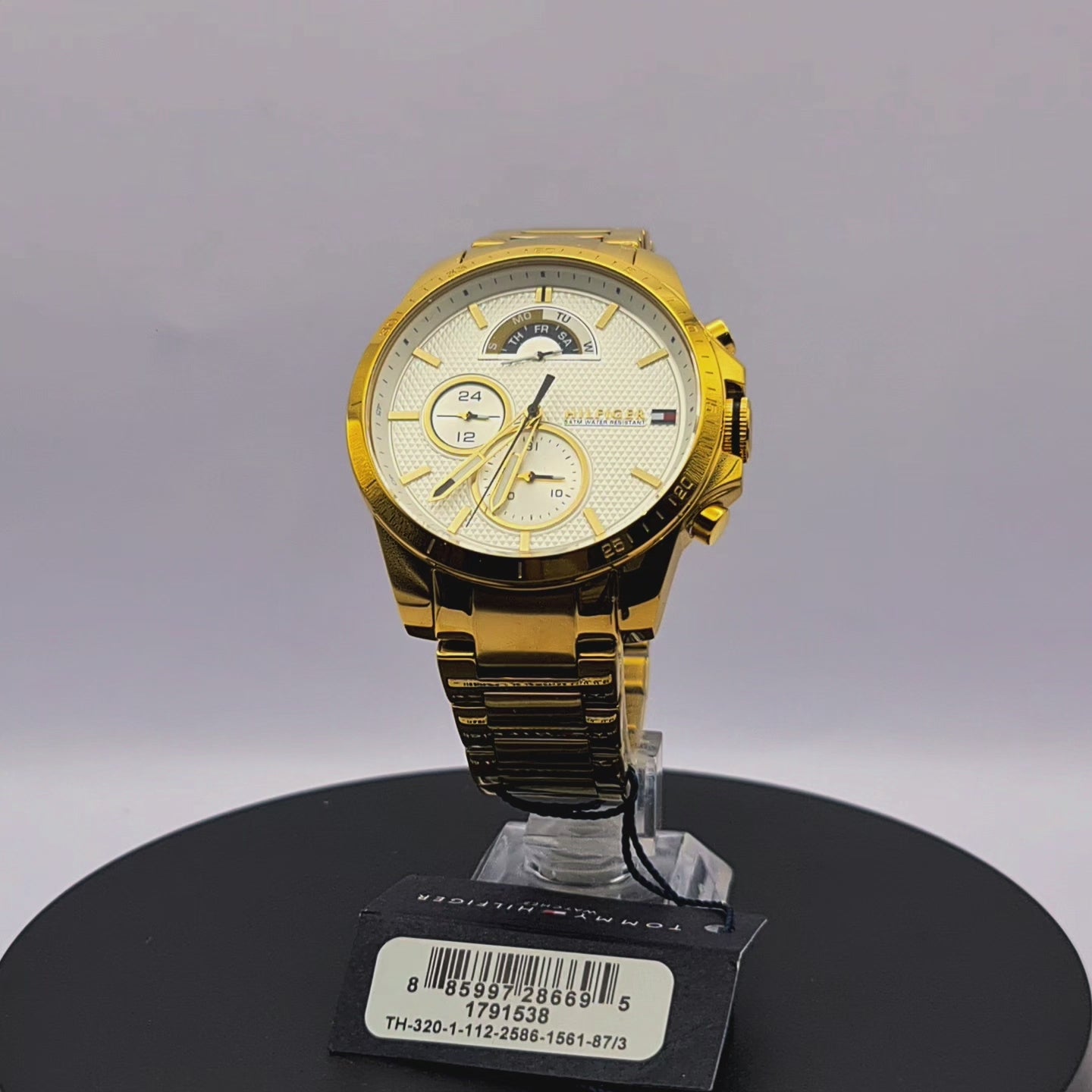 360-degree rotating view of Tommy Hilfiger 1791538 men's gold-tone stainless steel mesh watch with navy blue dial.