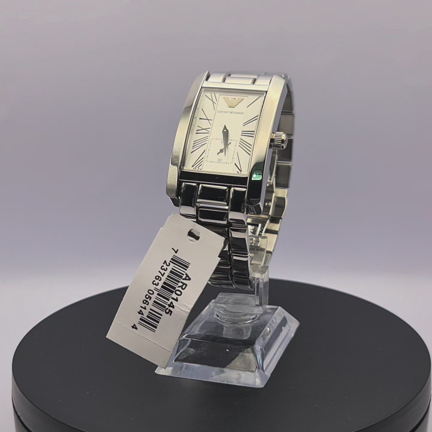 360-degree rotating view of Emporio Armani AR0145 men's silver stainless steel watch with white dial and rectangular case.