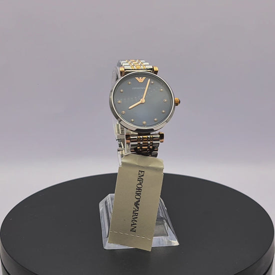 360-degree rotating view of Emporio Armani AR11092 Gianni T-Bar women's two-tone stainless steel watch with blue dial and crystal markers.