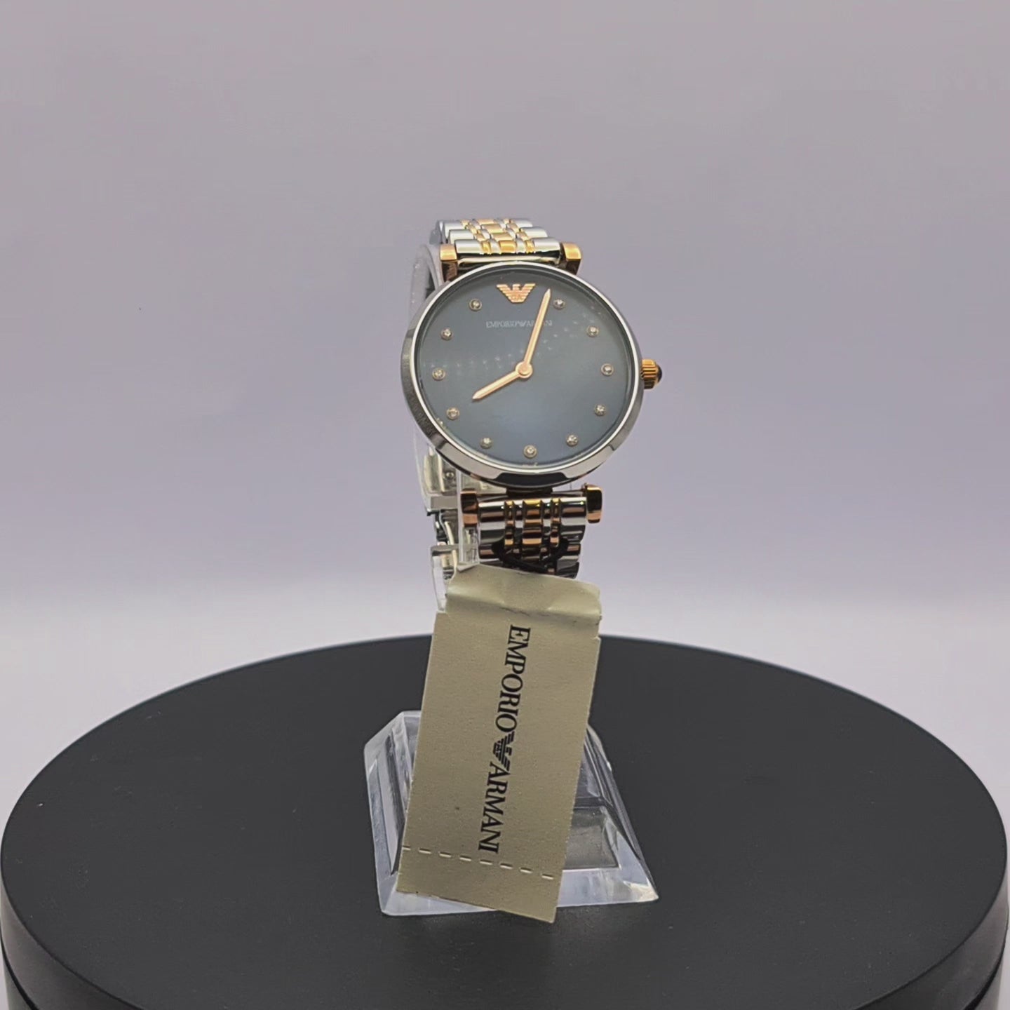 360-degree rotating view of Emporio Armani AR11092 Gianni T-Bar women's two-tone stainless steel watch with blue dial and crystal markers.
