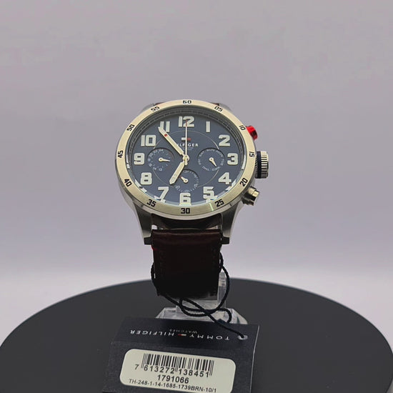 360-degree rotating view of Tommy Hilfiger 1791066 men's silver stainless steel watch with navy blue dial and brown leather strap.