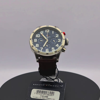 360-degree rotating view of Tommy Hilfiger 1791066 men's silver stainless steel watch with navy blue dial and brown leather strap.