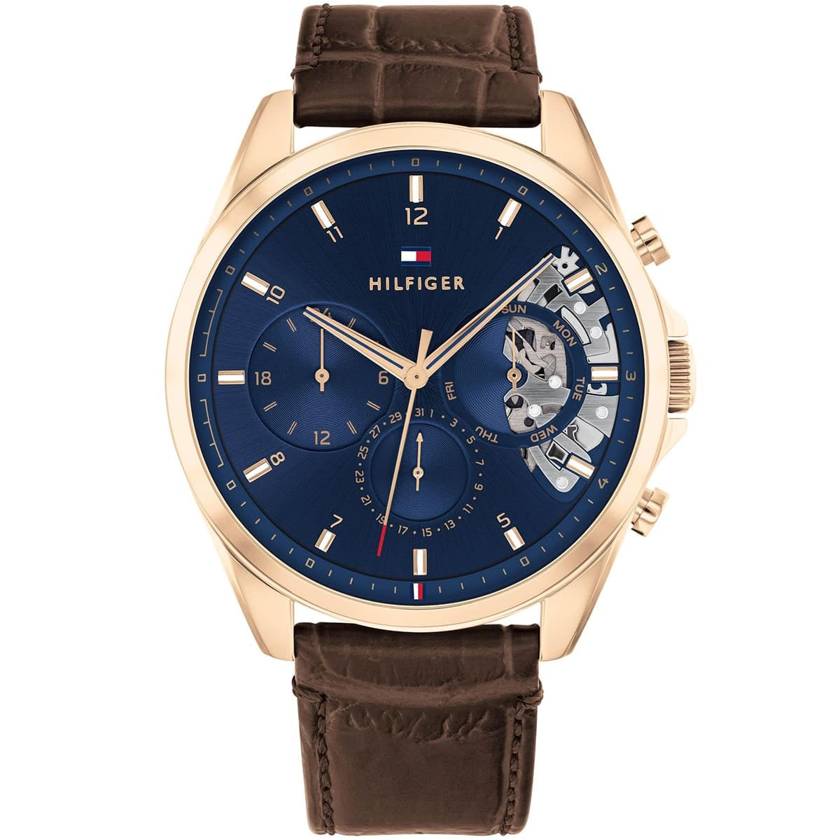 Front view of the Tommy Hilfiger 1710453 Baker men's watch featuring a blue dial with open-heart skeleton aperture and brown crocodile-embossed leather strap.