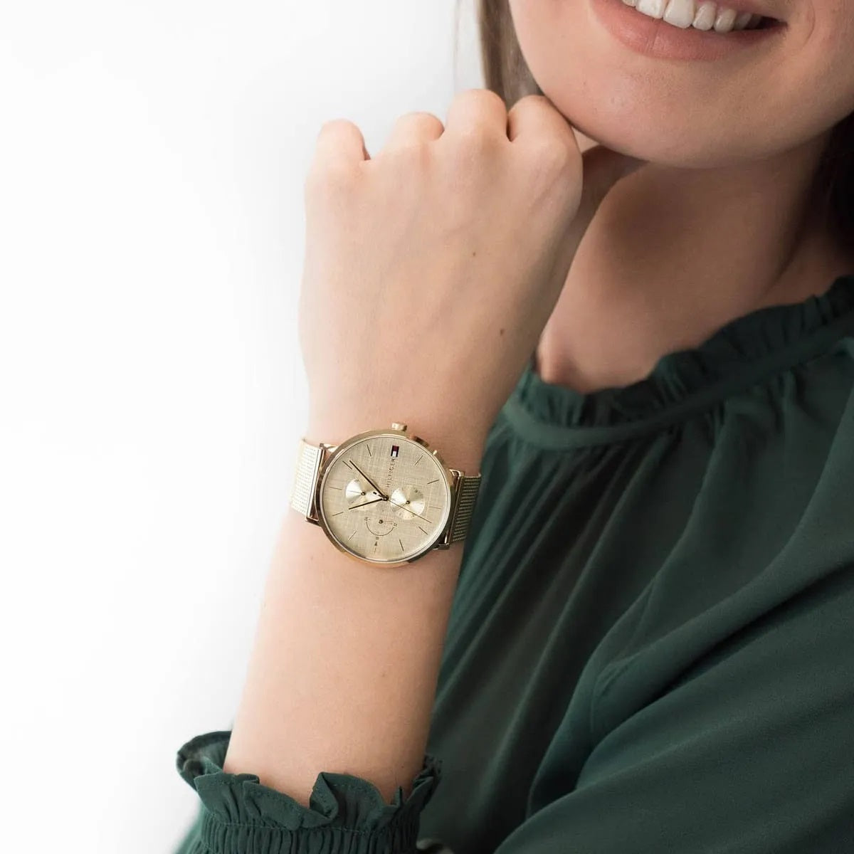 Tommy Hilfiger 1781943 women’s gold dial watch worn on wrist showing the stunning gold mesh strap design