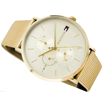 Close-up shot of Tommy Hilfiger 1781943 women's watch highlighting the gold mesh strap and gold dial