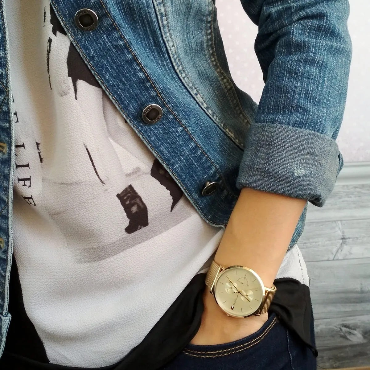 Tommy Hilfiger 1781943 women’s gold mesh strap watch worn on wrist showcasing its elegant gold dial