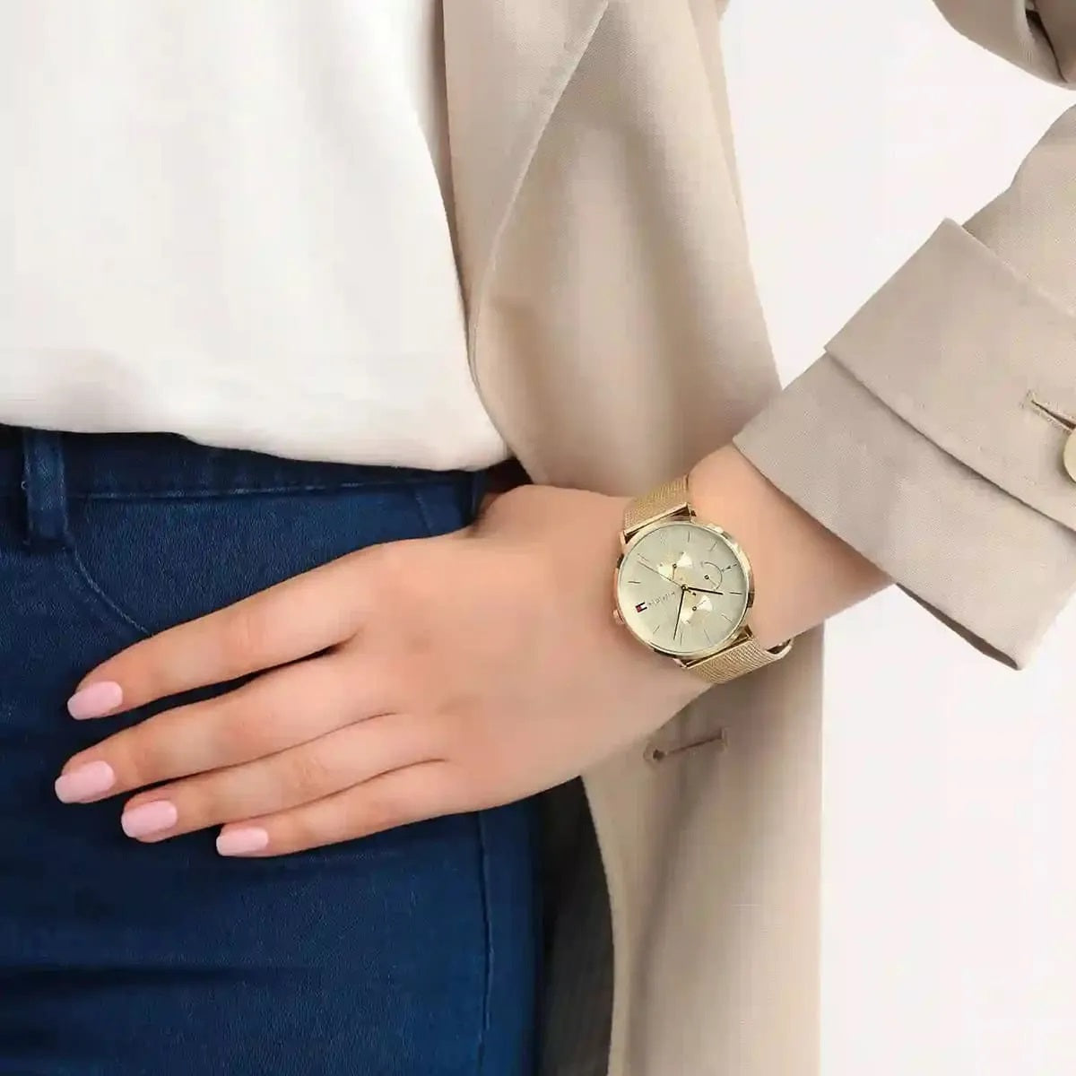 Tommy Hilfiger 1781943 women’s watch with gold dial and mesh strap worn on wrist for a refined look