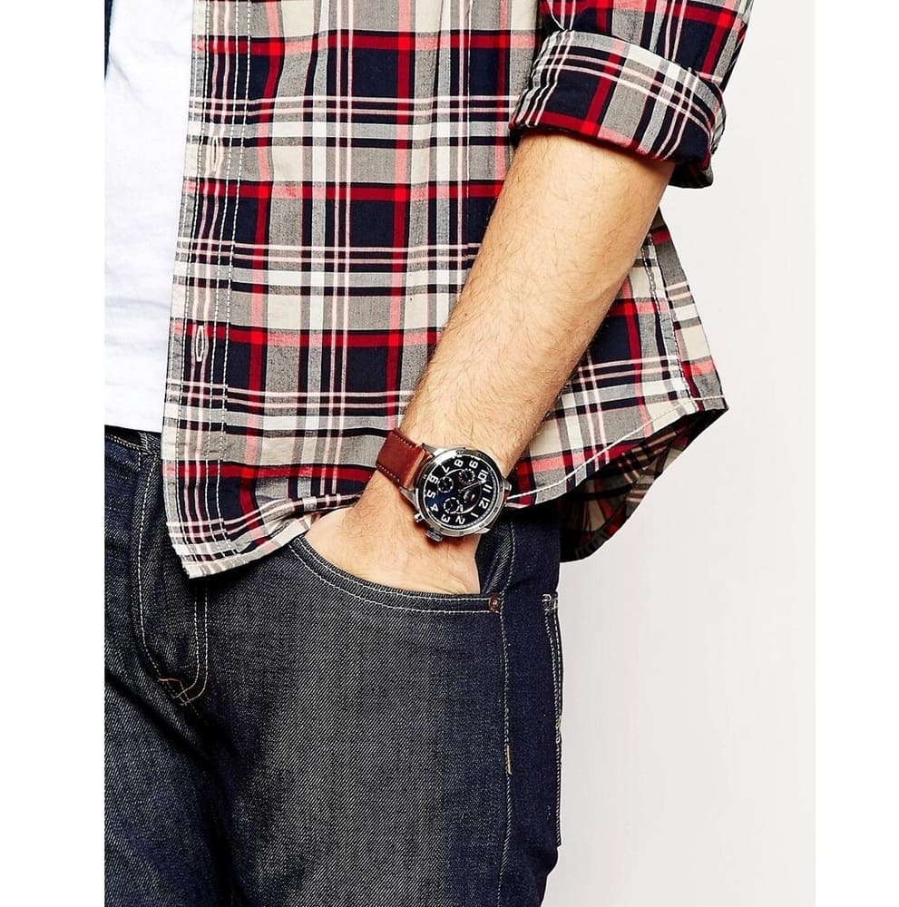 Wider on-wrist view of Tommy Hilfiger 1791066 men’s watch with brown leather strap, blue dial, and silver case