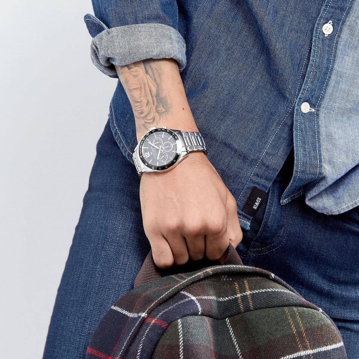 Tommy Hilfiger 1791104 men's silver stainless steel watch with black dial worn on wrist