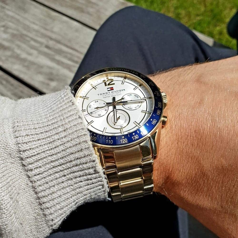 Close-up of dial hands and hour markers on Tommy Hilfiger 1791121 white dial watch