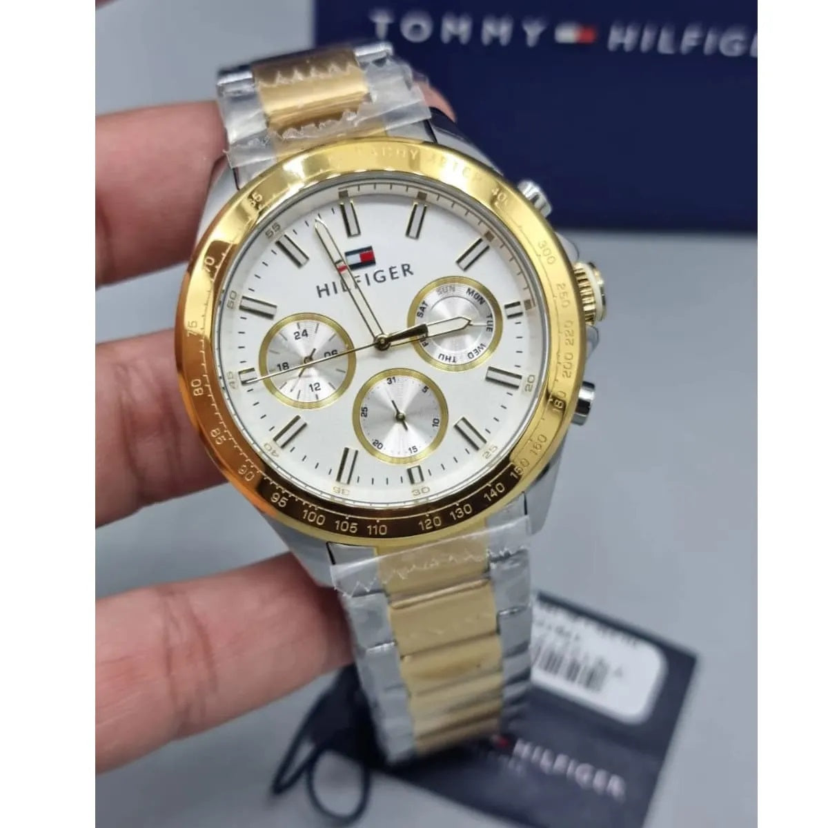 Angled view of Tommy Hilfiger 1791226 men's watch showing white dial and two-tone strap