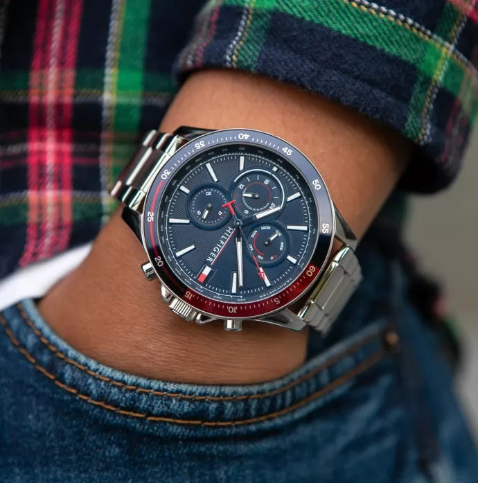 Tommy Hilfiger 1791718 men’s watch with blue dial worn on wrist to pockets