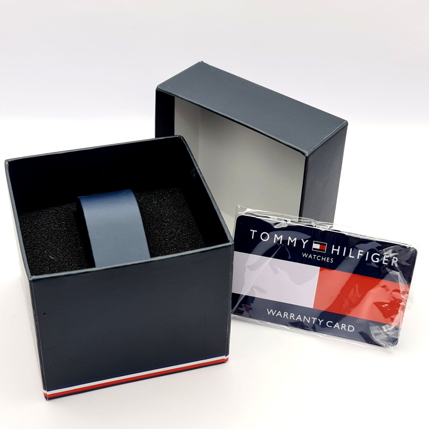 Official Tommy Hilfiger watch box with card and documents inside.